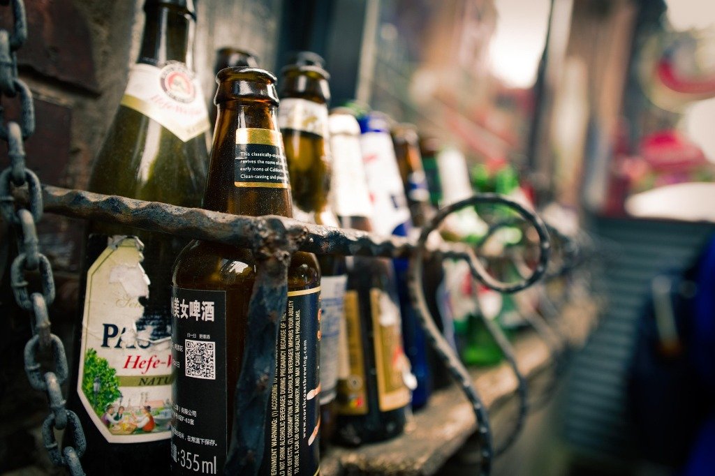 Artisanal craft beer bottles in iron racks at Madhuloka Bangalore